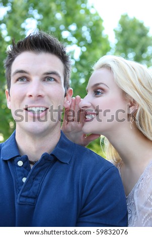 Young man and woman couple in love telling secrets