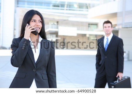 A pretty indian business woman on the phone at office building
