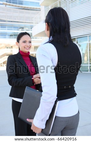 A pretty young women business team at the office building shaking hands