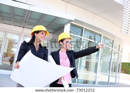 A pretty business woman construction team at office building with plans