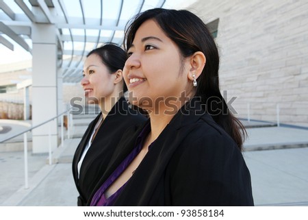 Two attractive Chinese business women at office building