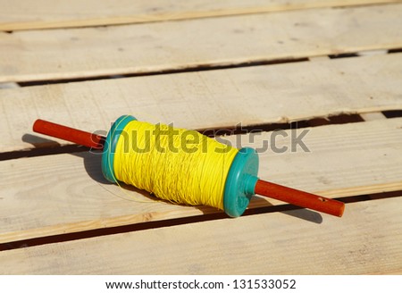 A beautiful spindles with yellow thread to fly kites