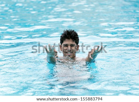A young fit swimmer posing in swimming pool