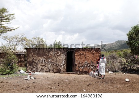 MASAI MARA, KENYA-OCTOBER 19: A traditional Masai hut made of cow dung, mud, bamboo and woods on October 19, 2013,  in a Masai village, Kenya