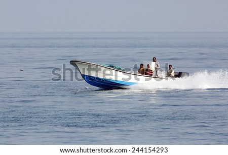BUSAITEEN, BAHRAIN-SEPTEMBER 27: Early morning fisher men moving in the sea on speedboat with fishing nets at Busaiteen sea coast on September 27, 2014, Bahrain