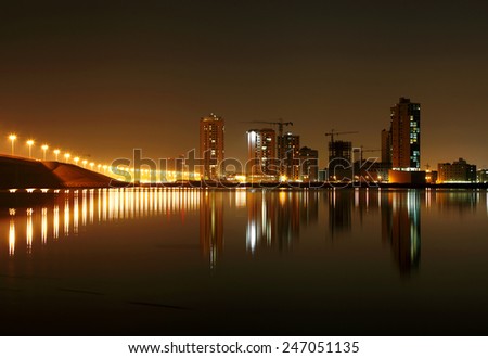 Illuminated street lights and Juffair buildings with reflection, Bahrain