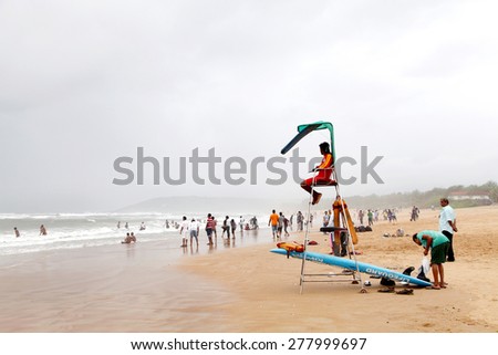 GOA, INDIA- AUGUST 10: A lifeguard sitting on surveillance tower for public safety at Calangute beach, Goa  on August 10, 2014