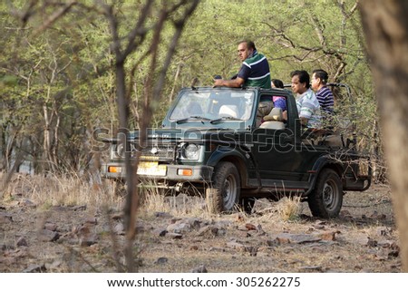 RANTHAMBORE, INDIA-JUNE 24: People eagerly waiting for tiger sighting in Safari jeep during game drive in Ranthambore National Park, Sawai Madhopur, India on June 24, 2015