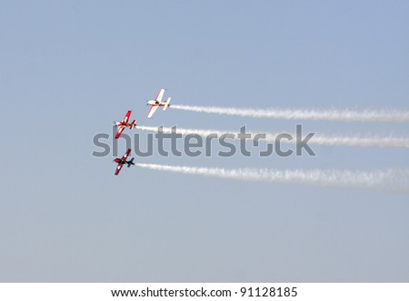 MUHARRAQ, BAHRAIN -DECEMBER 17: Stunts pilots from The Champions Aerobatic Show (TCAS) perform on December 17, 2011 on the occasion of Bahrain 40th National Day at Busaiteen beach in Muharraq, Bahrain