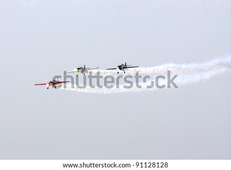 MUHARRAQ, BAHRAIN - DECEMBER 17: Stunts pilots from The Champions Aerobatic Show (TCAS) perform on December 17, 2011 on the occasion of Bahrain 40th National Day at Busaiteen beach in Muharraq, Bahrain