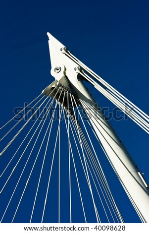 Cables supporting a footbridge in London against a blue sky