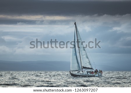 Similar – Image, Stock Photo Lonely yacht in gray water with dark mountains under cloudy sky