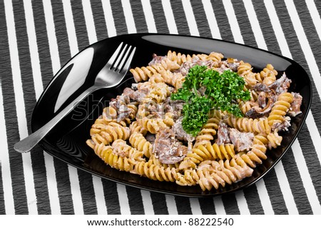 Cooked  pasta with meat and mushrooms