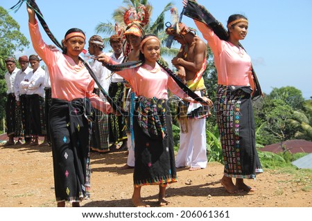 CECER VILLAGE, INDONESIA-APR.21: Women perform a traditional dance in costume for tourists visiting the Cecer Village on Flores Island, Indonesia on April 21, 2014.