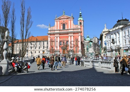 LJUBLJANA, SLOVENIA-MAR. 28, 2015:  Pedestrians gather on a sunny day in Preseren Square in Ljubljana.  The square is located in front of the old medieval city and is a popular gathering spot.