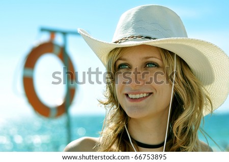 Young woman at the beach with ring-buoy on the background