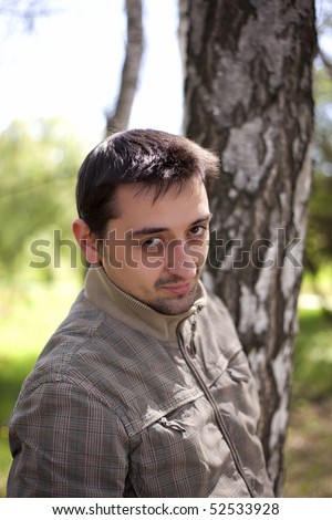 Cute young man posing in a forest