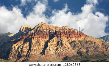 Mountain in Southwestern Nevada showing a geologic layer of iron oxide.