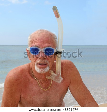 Active senior man ready to snorkel in the ocean