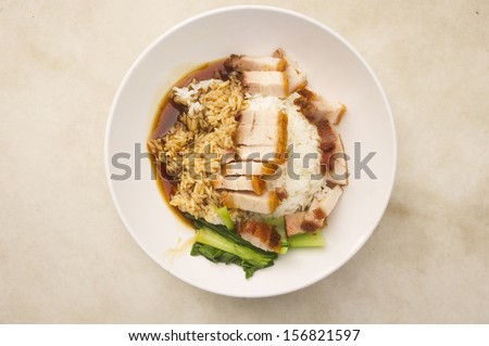 a close up of roasted pork with rice, a common chinese food found in singapore.