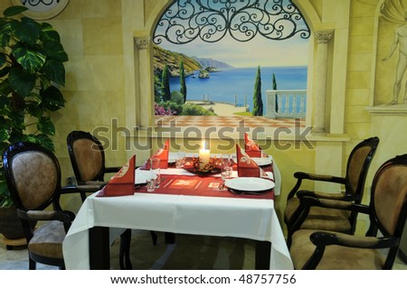 The beautiful romantic dining room with served table ready for guests.