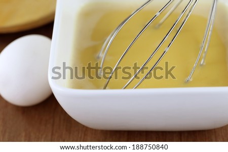 Egg beater in a kitchen with cooking ingredients