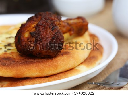 Garlic nan with grilled chiken on serving plate