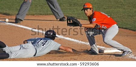 BANGOR, MAINE - AUGUST 15: Davis Atkins of U.S. Southwest slides back to first against Valerio Lucini of EMEA at the 2010 Senior League Baseball World Series on August 15, 2010 in Bangor, Maine.