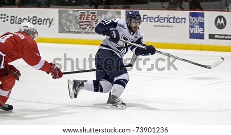 FREDERICTON, CANADA - MARCH 24: Jason Bast of St. FX scores against McGill at the 2011 CIS men\'s hockey championship tournament on March 24, 2011 in Fredericton, Canada.