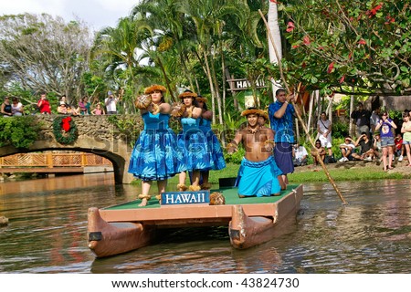 OAHU, HAWAII - DECEMBER 24: Polynesian Cultural Center. Students from University of Hawaii perform a traditional Hawaiian dance on a canoe on Christmas Eve, December 24, 2008.
