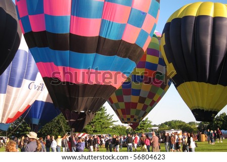 LISLE, IL - JULY 3: Hot Air Balloons prepare to takeoff in the morning sky at the Annual Hot Air Balloon Festival Eyes to the Skies and for celebration of Independence Day on July 3, 2010 in Lisle, IL