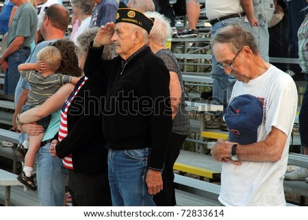 WOODSTOCK, IL - AUGUST 05: War Veterans salute those who died in the wars at the Farmers fair and machinery exhibition on August 5, 2010 in Woodstock, IL