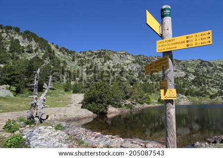 CHAMROUSSE, FRANCE, JULY 15, 2014 : Sign for walking paths around Chamrousse ski resort near Lac Achard. Chamrousse is a well-known ski resort and the nearest of Grenoble city.