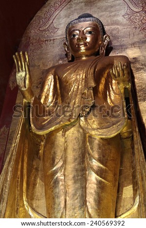 BAGAN, MYANMAR, December 10, 2014 : Ananda temple\'s Buddha statue. Bagan Archaeological Zone is a main draw for the country\'s tourism industry and is seen as equal in attraction to Angkor Wat.