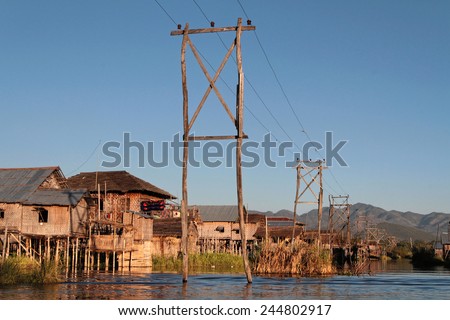 INLE LAKE, MYANMAR, December 14, 2014 : Electric poles on the lake .People built on the water its houses on piles and lives on culture of fruits, vegetables and flowers on incredible floating islands