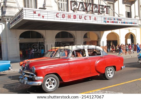 HAVANA, CUBA, FEBRUARY 15, 2014 : Classic old American car in the streets of Havana. Classic cars are still in use in Cuba and old timers have become an iconic view and a worldwide known attraction.