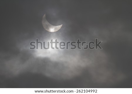 LYON, FRANCE, March 20, 2015 : Partial solar eclipse seen through a hole in the clouds