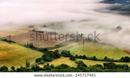 View into foggy countryside within early morning.