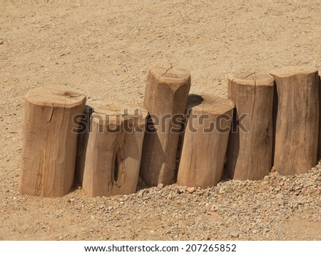 Old wooden palisade columns, old wooden stockade, fence, stony background
