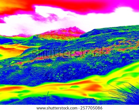 Alpine spring mountain stream  in infrared photo. Hilly landscape in background. Sunny weather with clear sky above. Amazing thermography colors