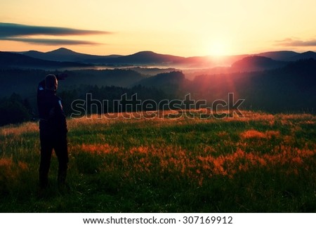 Meadow colorful sunrise with man silhouette