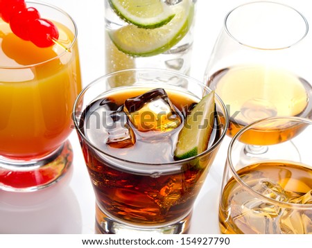 Various alcoholic cocktails on white background