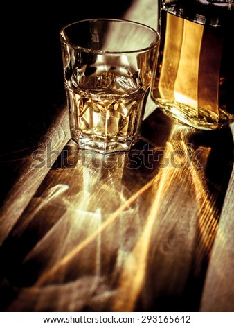 Whiskey on the rocks with back light and strong reflections