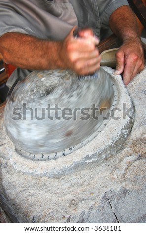 An old marble hand mill at work