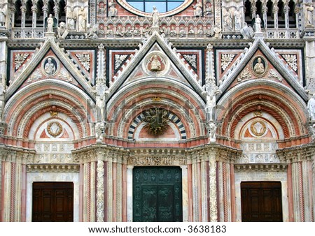 Detail of the beautiful and rich facade of the cathedral of Siena, the beautiful town in Tuscany, Italy