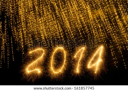 2014 written in sparkling letters under a curtain of sparks