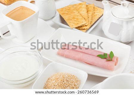 dietary breakfast with ham, yogurt, oat bran, and coffee or infusions