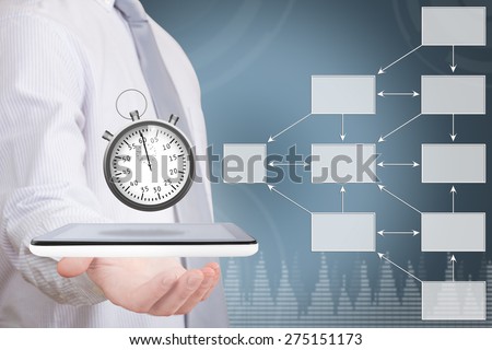 Businessman holding stopwatch on wireless device beside an empty organization chart