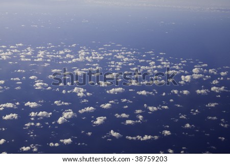 Clouds from above with ocean below
