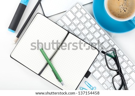 Blue coffee cup and office supplies. View from above. Closeup on white background